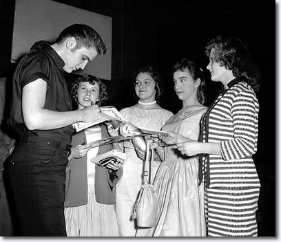 Elvis Presley signed autographs for four remarkably composed fans at the St. Paul, Minnesota Auditorium. 