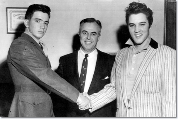 Pfc. Hershel Nixon (left) and Elvis Presley shake hands to show that all is well after the incident.